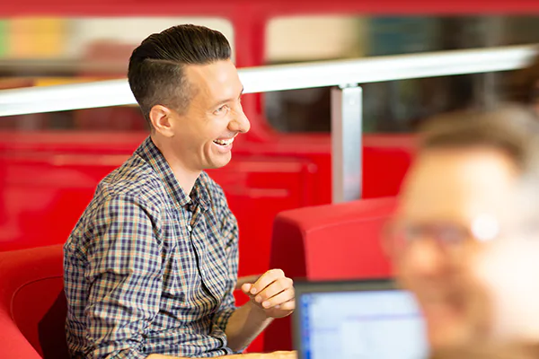 A man smiling while sitting at a table